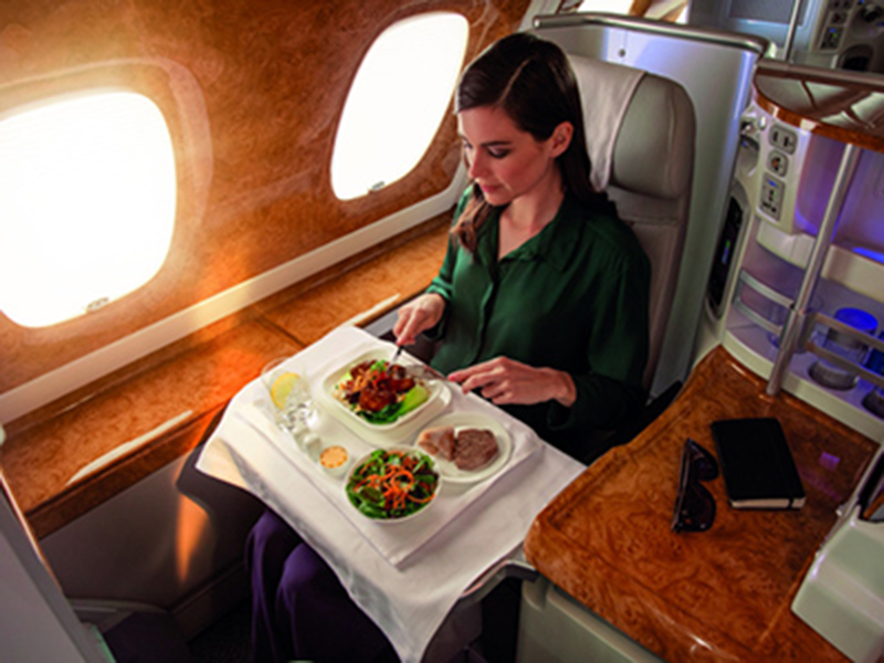 woman eating in business class travel